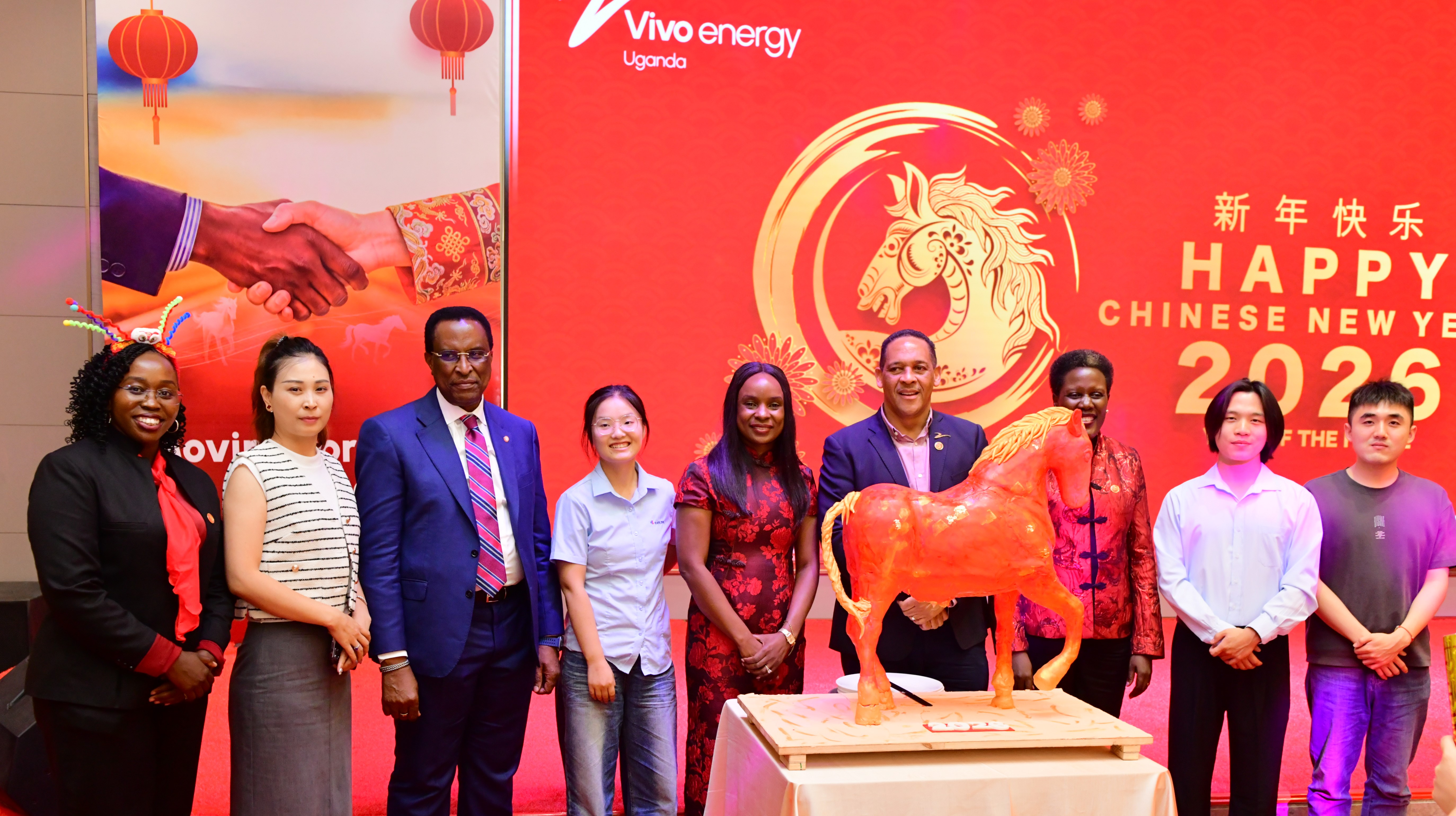 Members of Vivo Energy and the Chinese business community stand behind a model fire horse