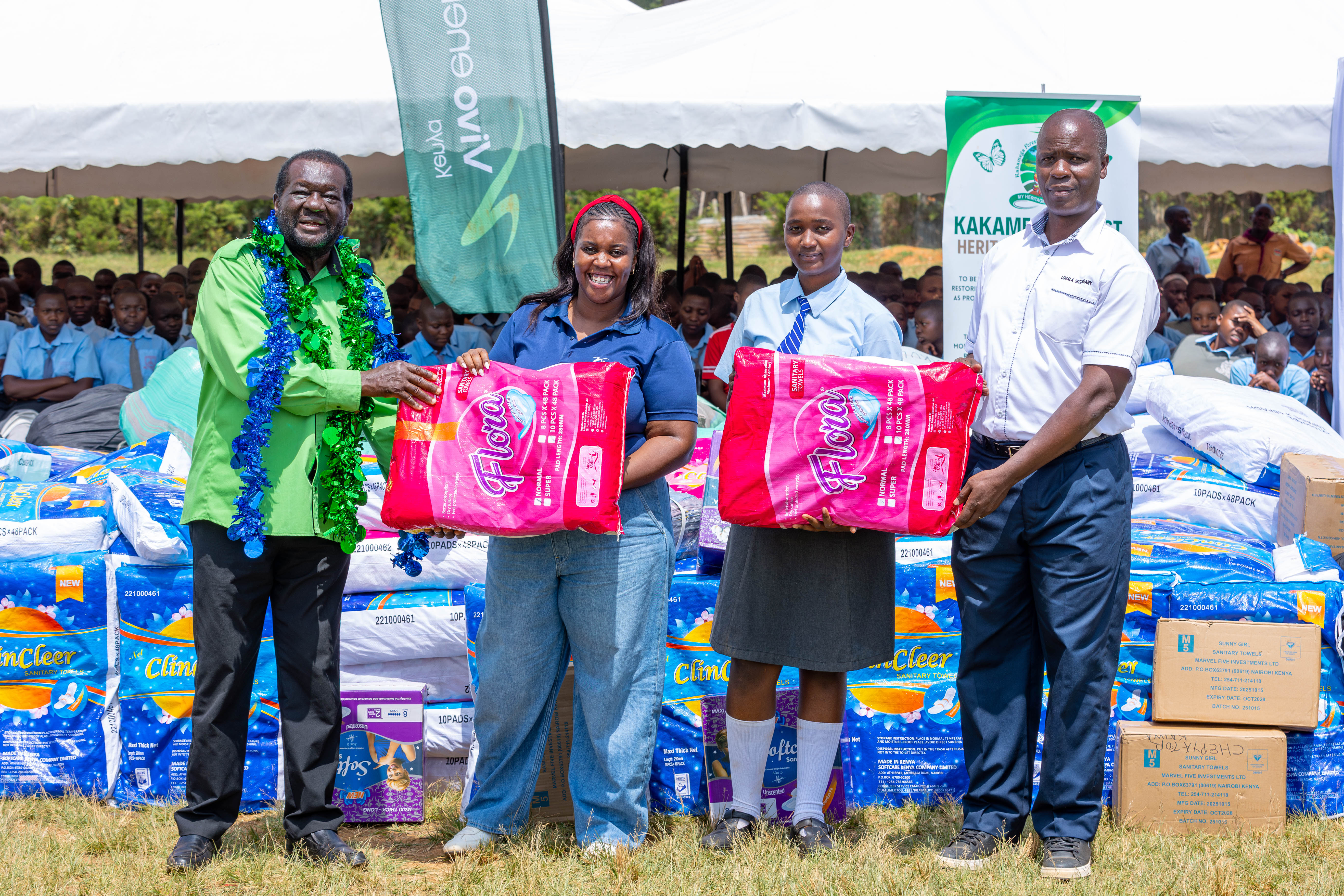 Representatives from the school and Kakamega Forest Heritage Foundation receive the donation of dignity packs