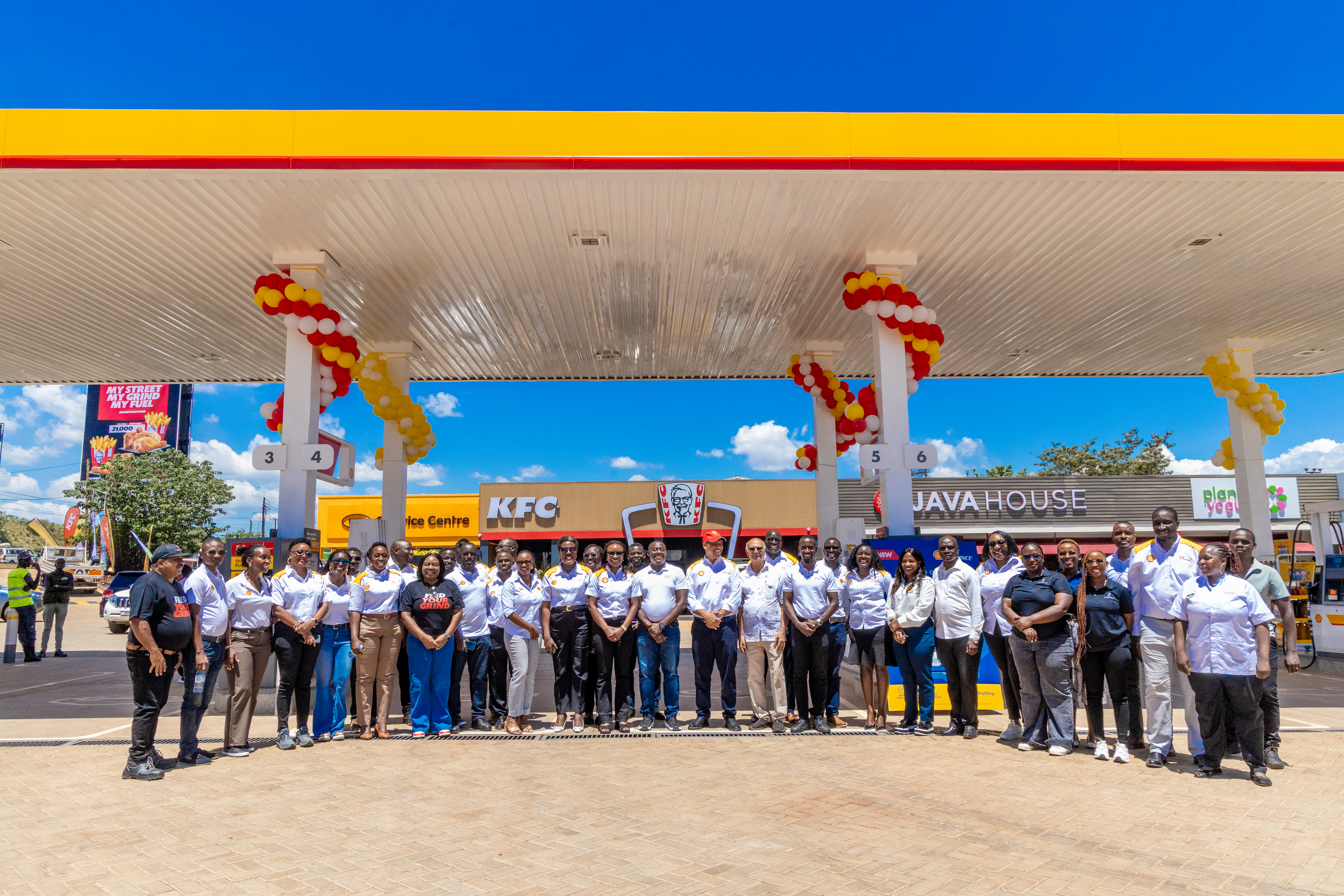 The Vivo Energy Uganda team stand in front of the redeveloped service station, Shell Amber Court